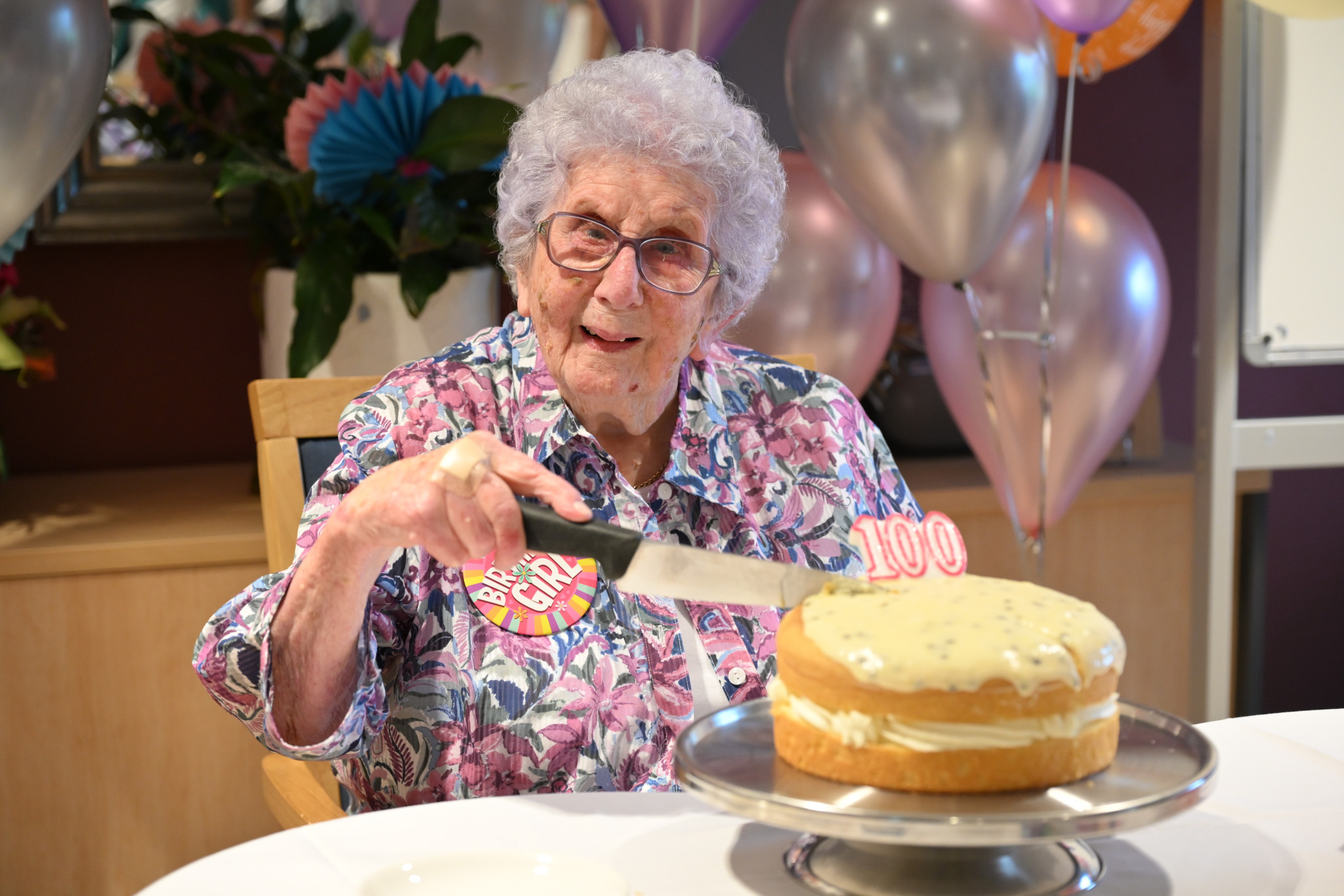 Mary Walklate cutting the cake. NCN PHOTOS