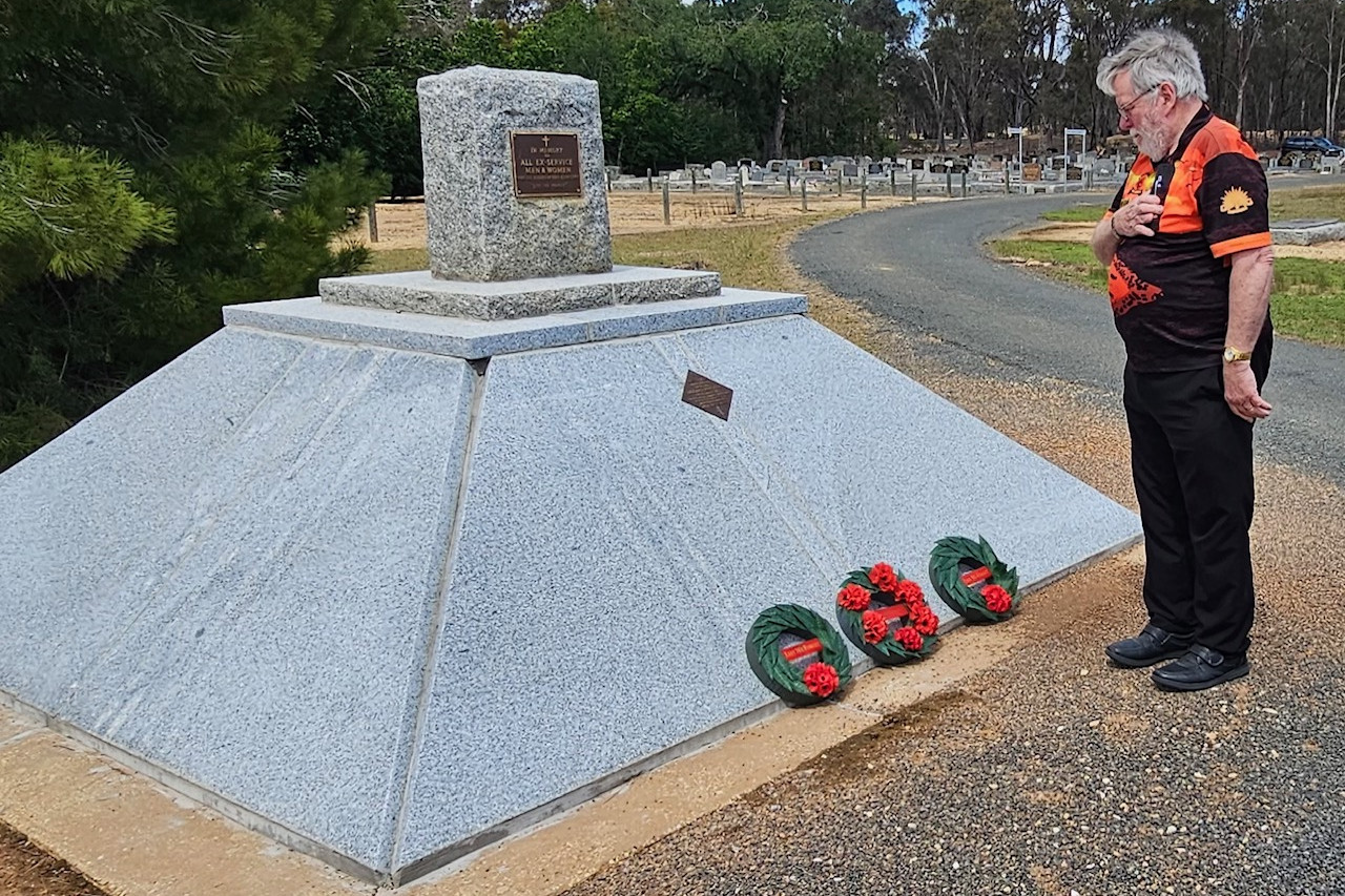 Gordon Wright honours his family at the restored memorial.