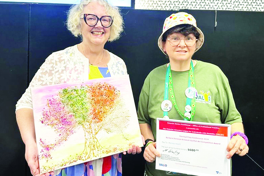 Melinda Hewitt (right) receiving her winner’s certificate along side her winning art piece.