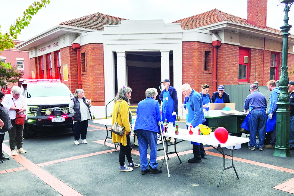 A steady community turnout at the Rotary BBQ between the Town Hall and the Post Office