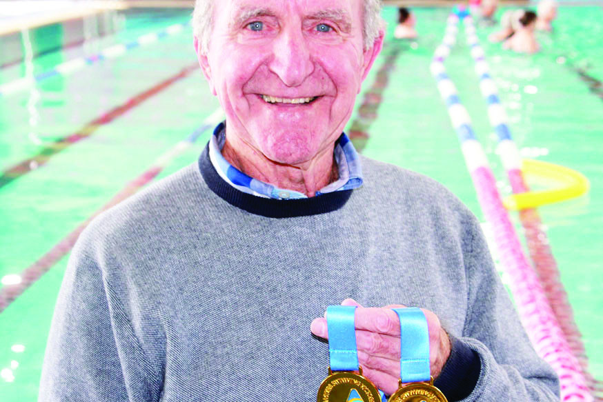 Wilfred Dickeson shows off his gold medals.