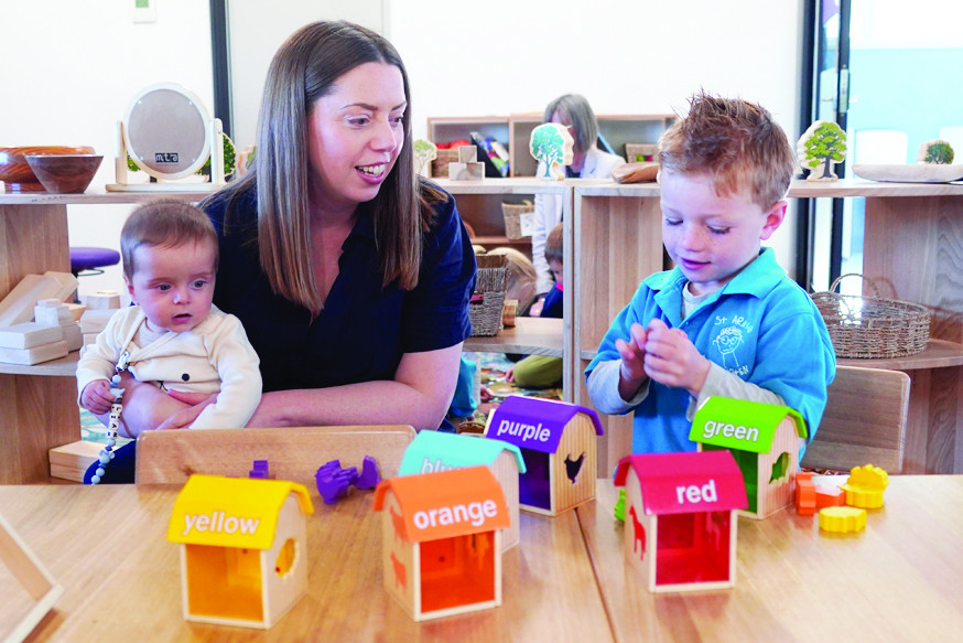 Member for Ripon Martha Haylett, with son Liam, chats to a pre-schooler at the Kinder last week.