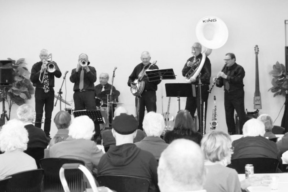 The Hot B’Hines (left to right) Bill Beasley (trombone, vocals), Ken Collins (trumpet, vocals), Brian Hodge (drums), David Hines (guitar, banjo and vocals), John Huf (sousaphone and stick bass), and Barry Currie (alto sax, soprano sax, clarinet, flute and vocals).
