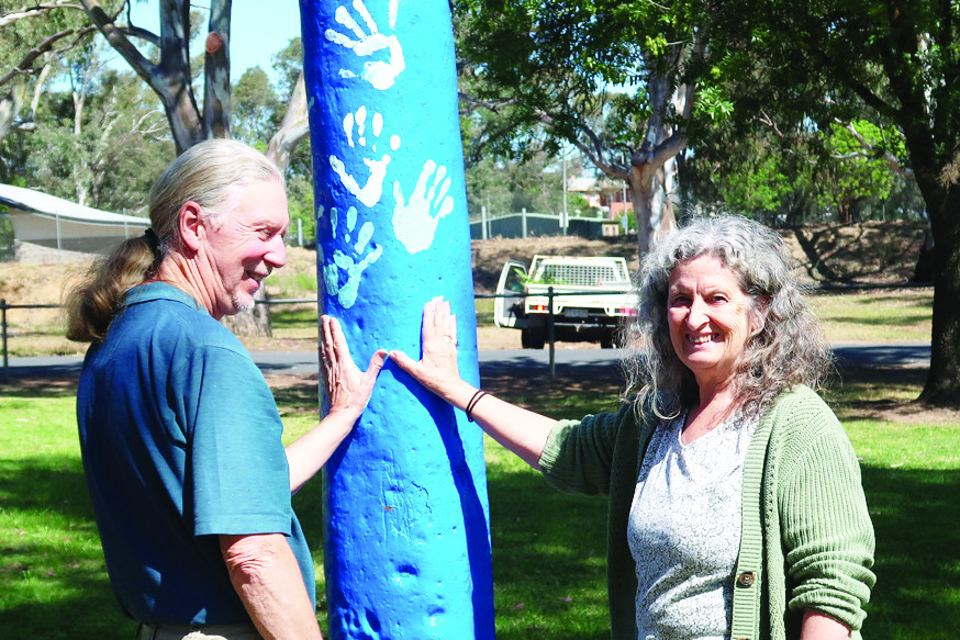 Community members (left to right) Geoff and Sue Stokes placing their hands