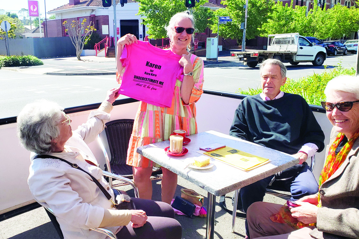 Karen Probst, candidate for Kara Kara Ward in the Northern Grampians election (holding her promotional T Shirt) with (left to right) Carol Campbell, Colin Jesse and Prue McAlister, share coffee outside the Parkview Cafe last weekend.