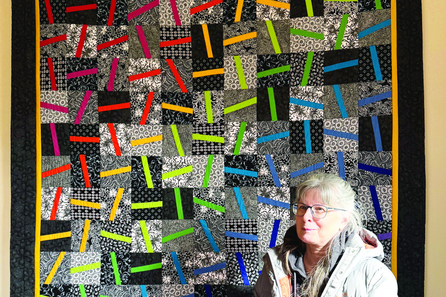 Donna McCallum with her quilt.