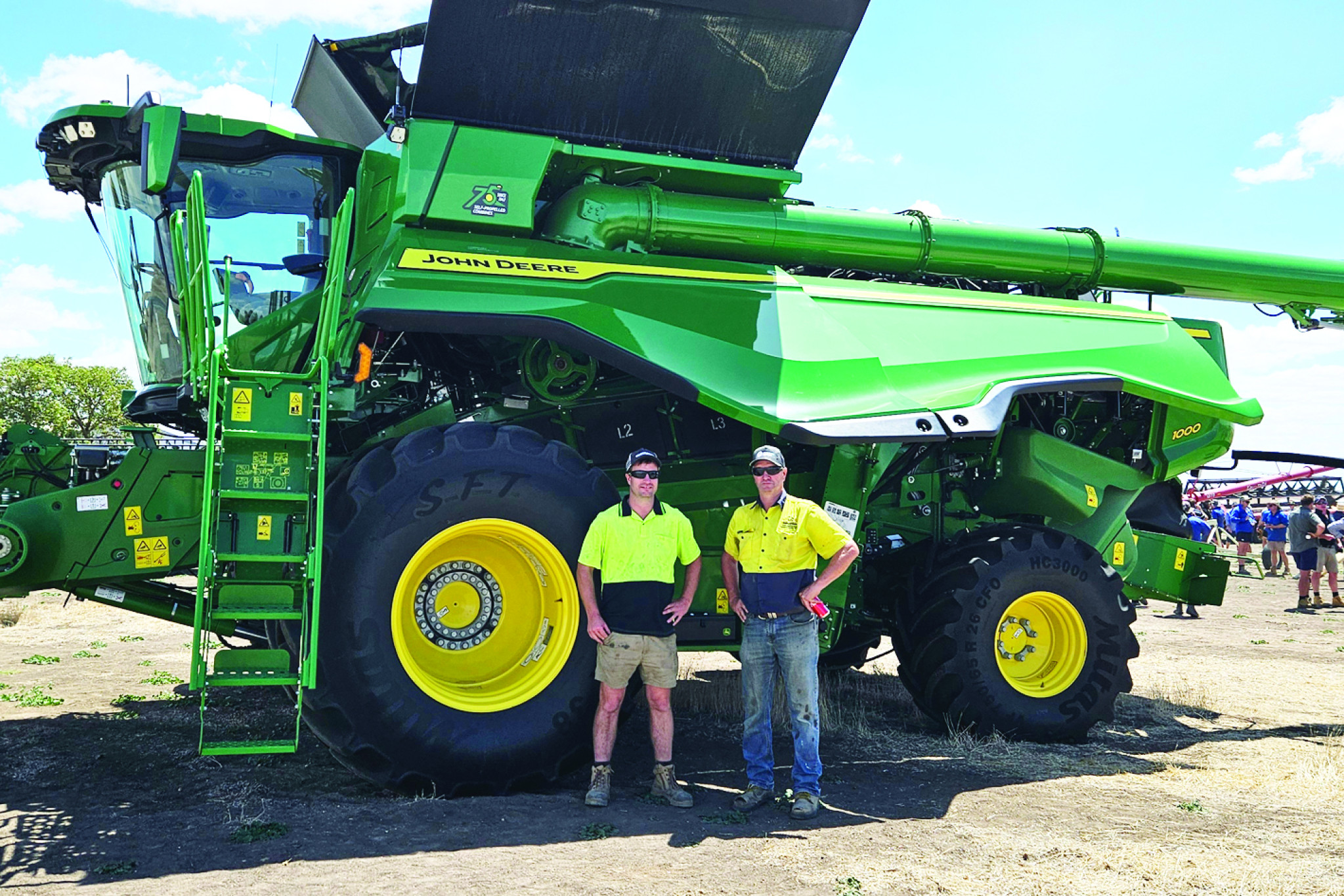 Matt (left) and father Andrew Weidemann infront of their purchase of their 2022 X9 John Deere Header which came with a 2022 John Deere Draper Front and 2022 John Deere BP15 Pickup Front.