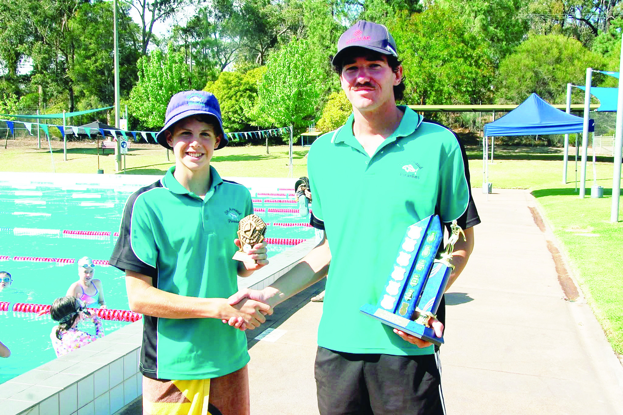 Jesse Amos (right) presenting Lewis Lowe with Leigh Amos Memorial Trophy at Saturday&rsquo;s swim meet