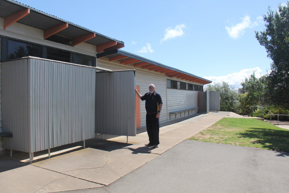 Principal Tony Hand pictured last year illustrating the toilet block as one of the areas of desperate need.