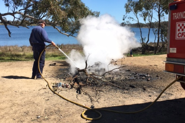 Traynors Lagoon CFA brigade puts more water on one campfire left unattended and still burning.